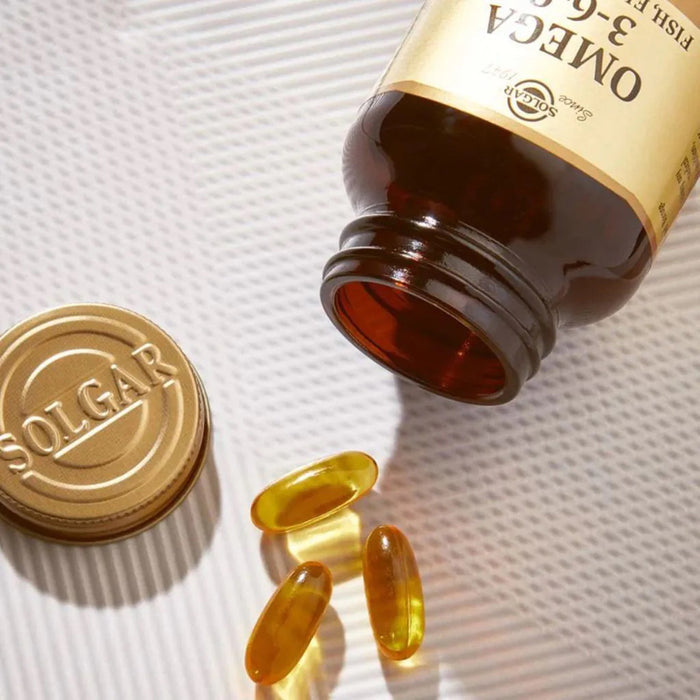 SOLGAR Omega 3-6-9 bottle with capsules on a textured surface
